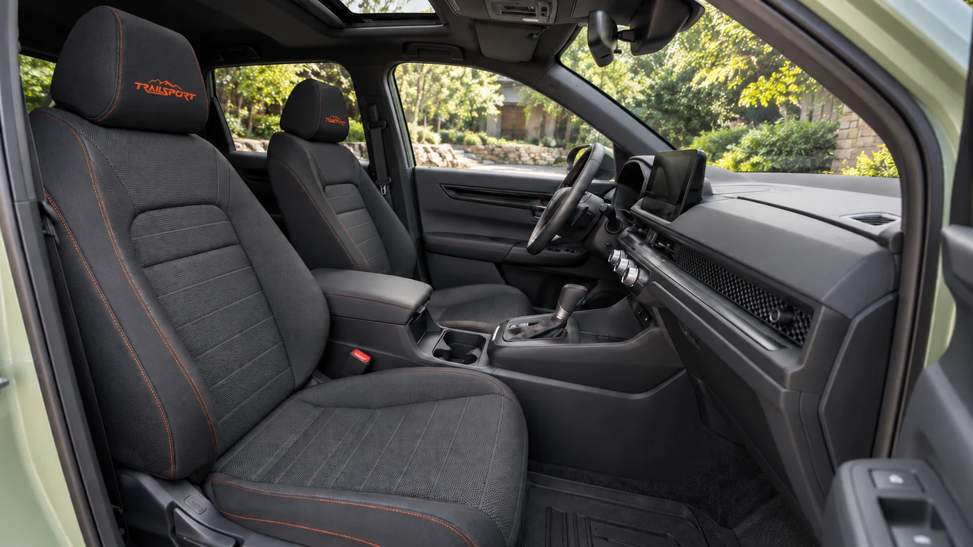 AI-generated illustration of a 2026 Honda CR-V TrailSport Hybrid front cabin with black cloth seats and orange stitching