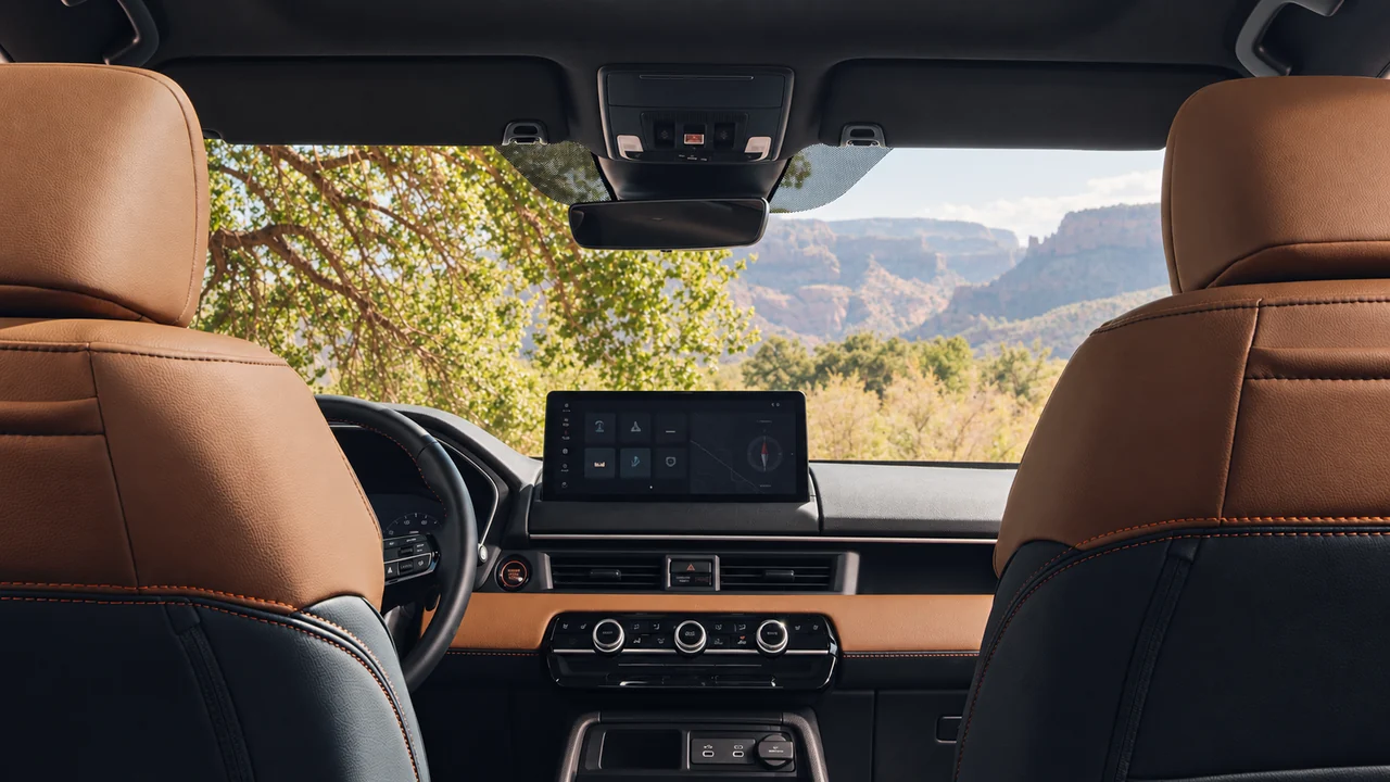 AI-generated illustration of the 2027 Passport TrailSport Elite brown-and-black front cabin viewed from the rear seats