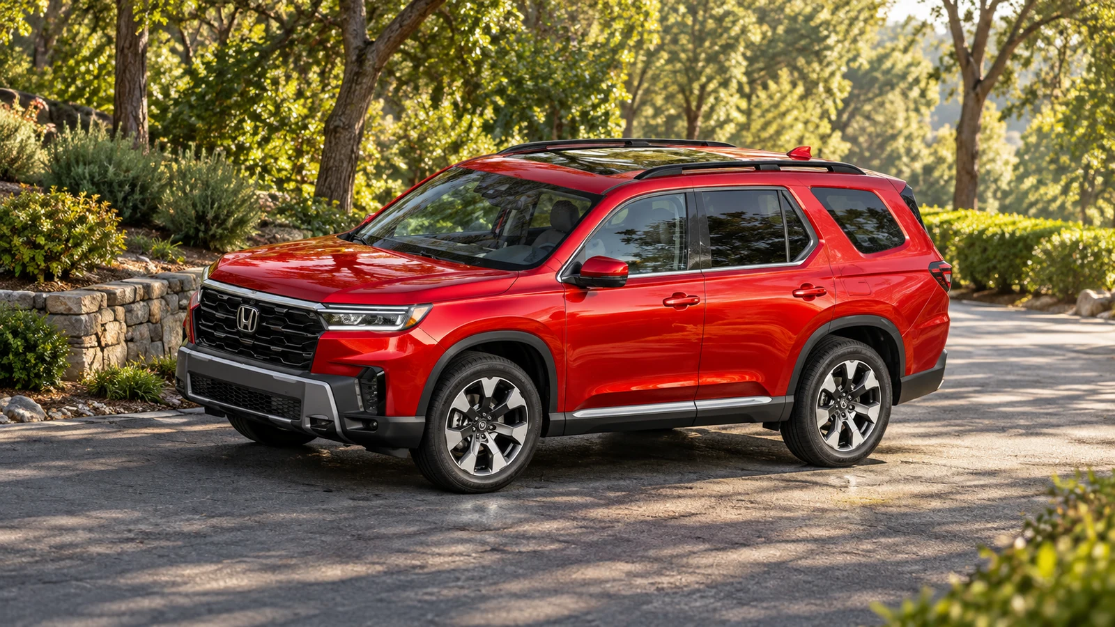 Red 2026 Honda Pilot parked on a tree-lined driveway