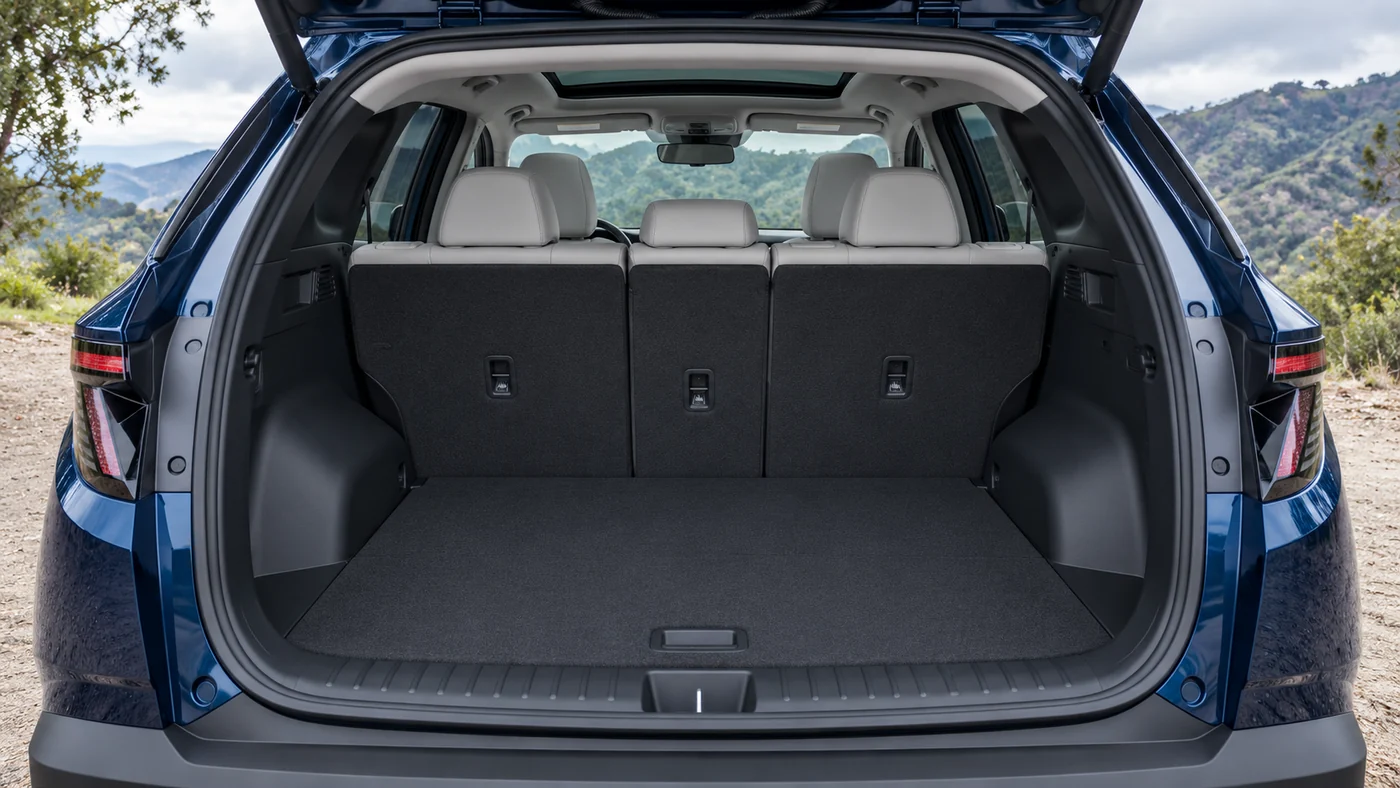AI illustration of a blue Tucson Limited with an open hatch and empty seats-up cargo area